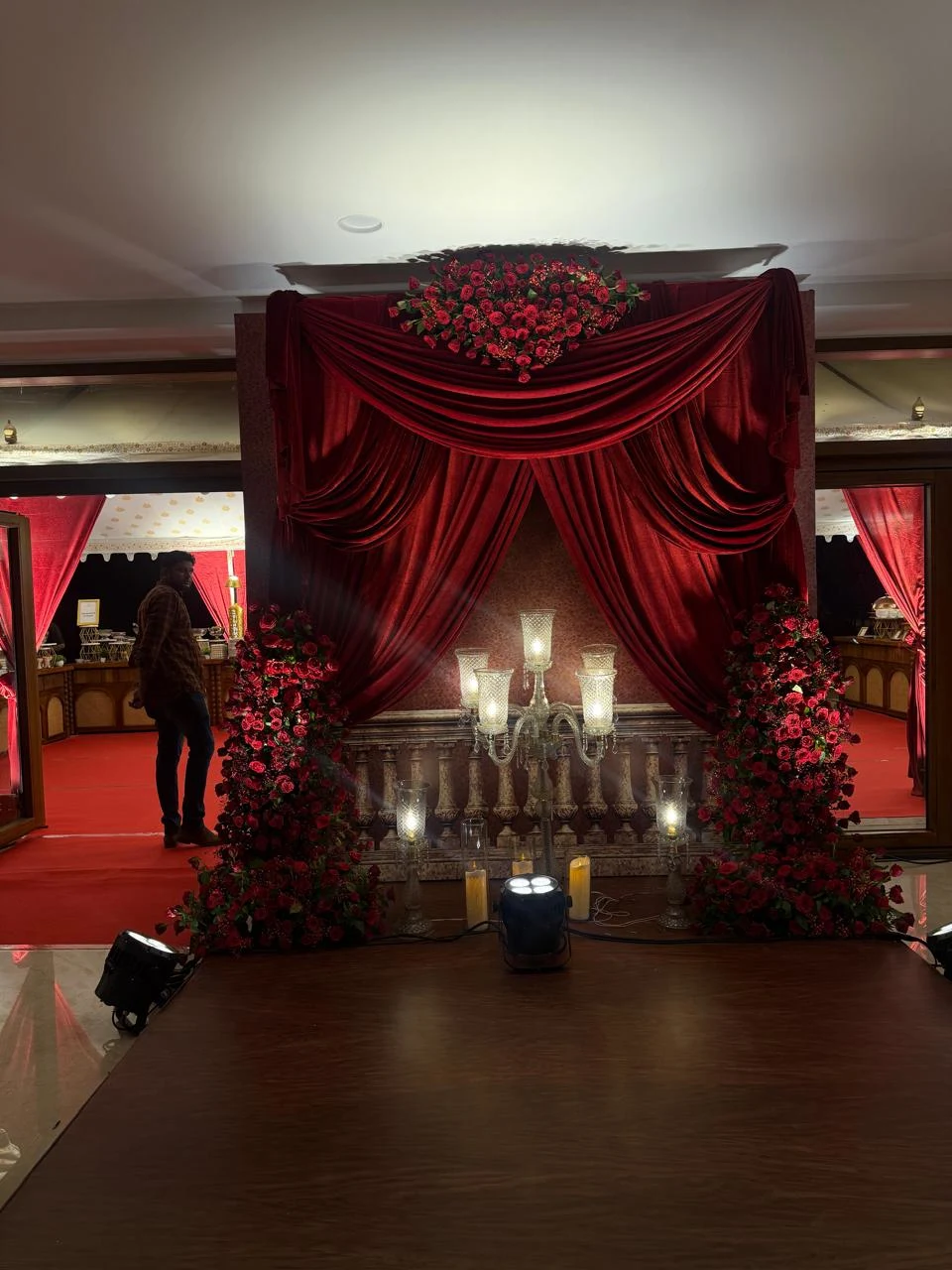 Close-up of cascading white roses and gold foliage on a wedding stage